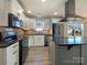 Modern kitchen with white cabinets, black countertops, and island at 1324 Crawford Rd # 6, Rock Hill, SC 29730