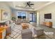 Virtually staged living room with gray couches and a large TV at 1324 Crawford Rd # 6, Rock Hill, SC 29730
