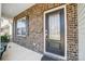 Modern black front door with glass panels and brick facade at 141 Lambeth Loop, Mooresville, NC 28115