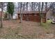 Rear exterior view of the brick home surrounded by mature trees at 1418 Nottingham Rd, Kannapolis, NC 28081
