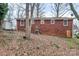 View of the home's backyard, featuring a red brick exterior, and yard space at 1418 Nottingham Rd, Kannapolis, NC 28081