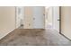 Bedroom with neutral carpet and paint and access to the bathroom at 1418 Nottingham Rd, Kannapolis, NC 28081
