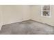 A carpeted room with cream walls, a white trim, and a window at 1418 Nottingham Rd, Kannapolis, NC 28081