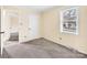 A carpeted room with cream walls, white trim, and a window overlooking a street at 1418 Nottingham Rd, Kannapolis, NC 28081