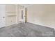 View of the bedroom, with access to other rooms, features neutral walls and gray carpet at 1418 Nottingham Rd, Kannapolis, NC 28081