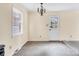 Bright dining room featuring a window, stylish light fixture, and a white door at 1418 Nottingham Rd, Kannapolis, NC 28081