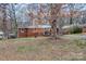 Charming brick home with mature trees, a cozy porch, and a well-maintained lawn at 1418 Nottingham Rd, Kannapolis, NC 28081