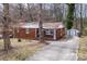 Charming brick home with a covered front porch and ample parking space at 1418 Nottingham Rd, Kannapolis, NC 28081