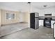 An open-concept kitchen features stainless steel appliances, white cabinets, and flows into the living area at 1418 Nottingham Rd, Kannapolis, NC 28081