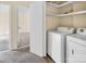 A well-lit laundry room features a washer, dryer, and ample storage space at 1418 Nottingham Rd, Kannapolis, NC 28081