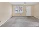 A spacious living room offers natural light from the window and a ceiling fan at 1418 Nottingham Rd, Kannapolis, NC 28081