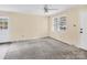 A well-lit living room has a ceiling fan and a view of the front yard through the window at 1418 Nottingham Rd, Kannapolis, NC 28081