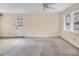Bright living room featuring neutral paint, a ceiling fan, and a door to the outside at 1418 Nottingham Rd, Kannapolis, NC 28081