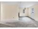 A brightly lit living room features easy access to the kitchen and to the front door at 1418 Nottingham Rd, Kannapolis, NC 28081
