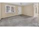 A bright living room features ample natural light from the window and leads to the front door at 1418 Nottingham Rd, Kannapolis, NC 28081