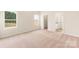 Spacious bedroom with carpet, large windows, and access to en-suite bathroom at 150 Adams Tree Way, Troutman, NC 28166