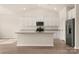 Modern kitchen featuring white cabinetry, granite countertops, and stainless steel appliances at 150 Adams Tree Way, Troutman, NC 28166