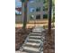 Backyard features a stone staircase, landscaped yard, and attractive home at 150 Driftwood Dr, Mooresville, NC 28117