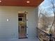Balcony view into living room with wood floors, stone fireplace, and neutral color palette at 150 Driftwood Dr, Mooresville, NC 28117