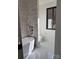 Modern bathroom with a freestanding tub, stone accent wall, and sleek fixtures at 150 Driftwood Dr, Mooresville, NC 28117