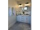 Bright bathroom featuring double sinks with modern fixtures and a large round mirror at 150 Driftwood Dr, Mooresville, NC 28117