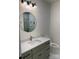 This half-bathroom features granite countertops, neutral cabinets, a round mirror, and a toilet at 150 Driftwood Dr, Mooresville, NC 28117