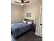 Neutral bedroom with ceiling fan, wooden bed frame, and wood flooring near a white door at 150 Driftwood Dr, Mooresville, NC 28117