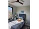 Cozy bedroom featuring a ceiling fan, a picture on the wall, and a window with outside views at 150 Driftwood Dr, Mooresville, NC 28117