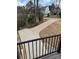 View of long, curved driveway from balcony overlooking a well-maintained lawn at 150 Driftwood Dr, Mooresville, NC 28117