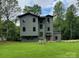 Modern two-story home boasts gray siding, a lush green lawn, and tasteful landscaping at 150 Driftwood Dr, Mooresville, NC 28117