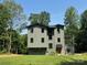 Stunning three-story home featuring modern architecture and lush landscaping at 150 Driftwood Dr, Mooresville, NC 28117