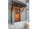 Beautiful wooden front door under an awning, adorned with a seasonal wreath and rock landscaping at 150 Driftwood Dr, Mooresville, NC 28117