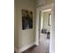 Hallway leading to a bedroom which features hardwood floors, a window, and a laundry basket at 150 Driftwood Dr, Mooresville, NC 28117