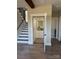 This interior shot showcases a home elevator, a staircase, and wood flooring at 150 Driftwood Dr, Mooresville, NC 28117