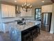 Modern kitchen featuring an island with seating, granite countertops, and stainless steel appliances at 150 Driftwood Dr, Mooresville, NC 28117