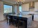 Bright kitchen featuring an island with seating, modern appliances, and stunning outdoor scenery at 150 Driftwood Dr, Mooresville, NC 28117