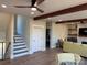 Open living room with stairs leading up to bedrooms and stone fireplace at 150 Driftwood Dr, Mooresville, NC 28117