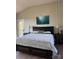 Comfortable main bedroom featuring a king bed, hardwood floors, and an art piece at 150 Driftwood Dr, Mooresville, NC 28117