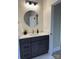 Stylish powder room featuring a modern vanity, round mirror, and stone accent wall at 150 Driftwood Dr, Mooresville, NC 28117