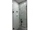 This tiled shower features a built-in shelf and a sleek glass door with black hardware at 150 Driftwood Dr, Mooresville, NC 28117