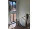 A staircase with wood steps and railings, alongside two windows and lots of natural light at 150 Driftwood Dr, Mooresville, NC 28117