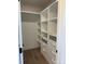 This image showcases a walk-in closet with custom built-in storage solutions at 150 Driftwood Dr, Mooresville, NC 28117