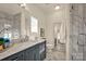 Bathroom with marble vanity, shower, and large mirror at 156 Singleton Rd, Mooresville, NC 28117