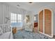 Bright Bedroom featuring a crib, armchair, and built-in wardrobe at 156 Singleton Rd, Mooresville, NC 28117
