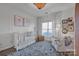 Bedroom with crib, armchair, and large window at 156 Singleton Rd, Mooresville, NC 28117