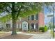 Charming brick townhome featuring a welcoming entrance, black shutters and well-maintained landscaping at 156 Singleton Rd, Mooresville, NC 28117