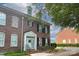 Charming brick townhome featuring a welcoming entrance, black shutters and well-maintained landscaping at 156 Singleton Rd, Mooresville, NC 28117