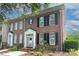 Charming brick townhome featuring a welcoming entrance, black shutters and well-maintained landscaping at 156 Singleton Rd, Mooresville, NC 28117