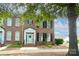 Charming brick townhome featuring a welcoming entrance, black shutters and well-maintained landscaping at 156 Singleton Rd, Mooresville, NC 28117