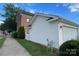 Garage and house corner exterior with an outside gas meter, white fence and manicured shrubs at 156 Singleton Rd, Mooresville, NC 28117